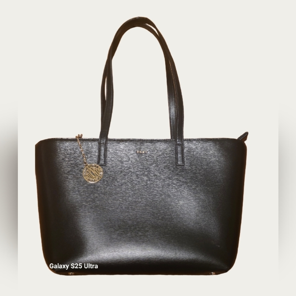 DKNY Bryant Medium Zippered Tote Bag in black leather with gold-tone hardware. 